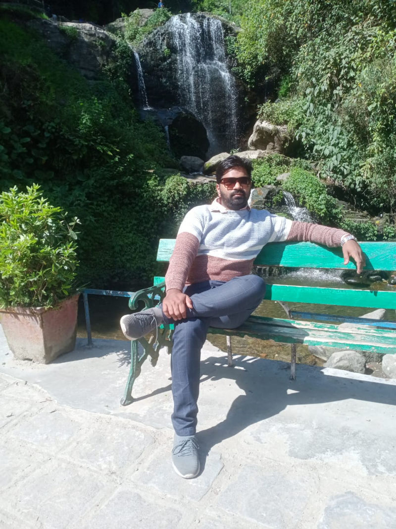 Sushil Singh - Sitting on bench near waterfall